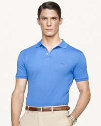 A sleek short-sleeved polo shirt in breathable mercerized stretch cotton piqué is cut for a trim, modern fit that channels timeless preppy athleticism. A sleek short-sleeved polo shirt in breathable mercerized stretch cotton piqué is cut for a trim, modern fit that channels timeless preppy athleticism.