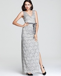 In shimmering, metallic lace, BCBGMAXAZRIA's long dress shows off a modern fabric with classic, ladylike appeal. A grosgrain ribbon belt ensures a flattering fit. In shimmering, metallic lace, BCBGMAXAZRIA's long dress shows off a modern fabric with classic, ladylike appeal. A grosgrain ribbon belt ensures a flattering fit.
