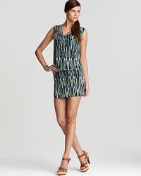 Cool tones stretch from cowl neckline to high hemline on this MICHAEL Michael Kors dress, abundant with a vibrant tribal print. Accentuate the exotic element with strappy leather sandals. Cool tones stretch from cowl neckline to high hemline on this MICHAEL Michael Kors dress, abundant with a vibrant tribal print. Accentuate the exotic element with strappy leather sandals.
