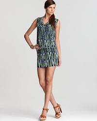 Cool tones stretch from cowl neckline to high hemline on this MICHAEL Michael Kors dress, abundant with a vibrant tribal print. Accentuate the exotic element with strappy leather sandals.