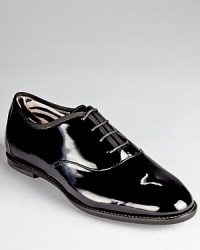 A tap dance inspired silhouette from Salvatore Ferragamo looks smart in glossy patent leather. A zebra print lining adds a playful touch. A tap dance inspired silhouette from Salvatore Ferragamo looks smart in glossy patent leather. A zebra print lining adds a playful touch.