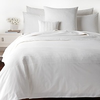 Clean, crisp and classic white, this elegant Barbara Barry decorative pillow boasts rows of fine pintuck pleats for a tailored statement of modern comfort. Clean, crisp and classic white, this elegant Barbara Barry decorative pillow boasts rows of fine pintuck pleats for a tailored statement of modern comfort.