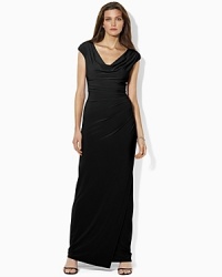 Crafted from fluid matte jersey, this graceful gown features an elegant draped neckline and flattering side-ruching for a sophisticated evening look. Crafted from fluid matte jersey, this graceful gown features an elegant draped neckline and flattering side-ruching for a sophisticated evening look.