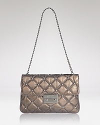 Quilted leather leaves an impression on this MICHAEL Michael Kors clutch, detailed with a classic turnlock closure. Its optional strap slides over the shoulder for hands free styling. Quilted leather leaves an impression on this MICHAEL Michael Kors clutch, detailed with a classic turnlock closure. Its optional strap slides over the shoulder for hands free styling.