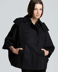 This Burberry Brit cape strikes at a distance with a fantastic shape and oversized form for a thoroughly modern silhouette. Layer over slim skinny jeans and march into the fashion horizon. This Burberry Brit cape strikes at a distance with a fantastic shape and oversized form for a thoroughly modern silhouette. Layer over slim skinny jeans and march into the fashion horizon.