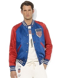 Celebrate Team USA's participation in the London 2012 Olympic Games with this versatile, reversible varsity jacket accented with patriotic patches and embroidery. Celebrate Team USA's participation in the London 2012 Olympic Games with this versatile, reversible varsity jacket accented with patriotic patches and embroidery.