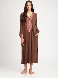 A zip-front silhouette featuring intricate jacquard trim in vivid colors for a bohemian-inspired effect. V-neckHalfway zip frontLong sleevesJacquard trim at the neckline and cuffsFront slash pocketsAbout 53 from shoulder to hemRayonHand washMade in China