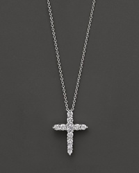 A diamond cross necklace. With signature ruby accent. Designed by Roberto Coin. A diamond cross necklace. With signature ruby accent. Designed by Roberto Coin.