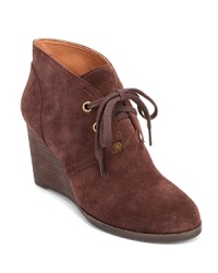 Lucky Brand adds interest to basic booties with bold metallic grommets and oversized laces. Lucky Brand adds interest to basic booties with bold metallic grommets and oversized laces.
