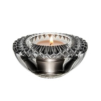 Embellished with intricately cut, angular facets that sparkle with reflected light, this votive candleholder from Orrefors adds an ornate element to the dining table.