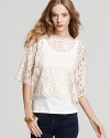 Embrace the lace--this beautiful, lightweight top with lace overlay looks great over a clean white cami or a colorful tank for a fun peek-through contrast.