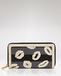 This kiss on our wish list: This MARC BY MARC JACOBS wallet is basic yet bold, styled in printed PVC. Its zip around closure opens to a well-organized interior with multiple pockets. This kiss on our wish list: This MARC BY MARC JACOBS wallet is basic yet bold, styled in printed PVC. Its zip around closure opens to a well-organized interior with multiple pockets.
