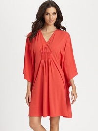 Wide sleeves and center ruching make for a flattering silhouette of soft-stretch fabric. V-neckThree-quarter length wide dolman sleevesCenter ruching for added drapeAbout 36 from shoulder to hem62% polyester/33% rayon/5% spandexMachine washImported