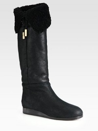 Cozy shearling lines this fold-over leather silhouette, topped with gleaming metal-tip ties. Stacked heel, 1 (25mm)Shaft, 13½Leg circumference, 13½Leather upperPull-on styleShearling liningRubber solePadded insoleMade in Italy Cozy shearling lines this fold-over leather silhouette, topped with gleaming metal-tip ties. Stacked heel, 1 (25mm)Shaft, 13½Leg circumference, 13½Leather upperPull-on styleShearling liningRubber solePadded insoleMade in Italy