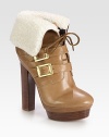Plush shearling softens this leather silhouette with goldtone hardware, thin laces and a towering stacked heel. Stacked heel, 5 (125mm)Stacked island platform, 1½ (40mm)Compares to a 3½ heel (90mm)Leather and shearling upperAdjustable buckle strapsLeather lining and solePadded insoleImported