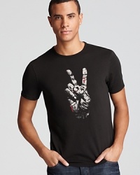 A weathered, bandaged hand flashes the peace symbol on the front of this striking graphic tee. Fight for peace in a tattoo-inspired font runs across the back. A weathered, bandaged hand flashes the peace symbol on the front of this striking graphic tee. Fight for peace in a tattoo-inspired font runs across the back.