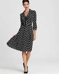 Playful polka dots lend a cheerful look to a timeless Anne Klein swing dress, exuding a faint retro feel. Playful polka dots lend a cheerful look to a timeless Anne Klein swing dress, exuding a faint retro feel.