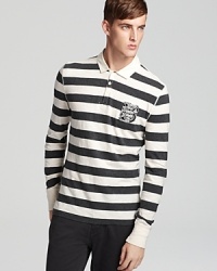 Burberry Brit's crest adorns this preppy polo in a bold rugby stripe. Burberry Brit's crest adorns this preppy polo in a bold rugby stripe.