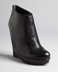 Sculpted, architectural wedge heels define these streamlined Dolce Vita booties. Sculpted, architectural wedge heels define these streamlined Dolce Vita booties.