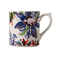 An opulent blue flower blooms from a backdrop of garden delights on the fresh, fun Eden mug from Gien France. An opulent blue flower blooms from a backdrop of garden delights on the fresh, fun Eden mug from Gien France.