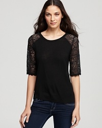 A ladylike front hides a sassy secret on this AG Adriano Goldschmied tee: a bold, sheer lace back shows off your slinky side. A ladylike front hides a sassy secret on this AG Adriano Goldschmied tee: a bold, sheer lace back shows off your slinky side.