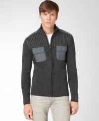 This classic fit military styled full zip ribbed sweater by Calvin Klein Jeans is perfect to keep you warm and stylish. This classic fit military styled full zip ribbed sweater by Calvin Klein Jeans is perfect to keep you warm and stylish.
