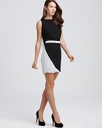 This Halston Heritage dress boasts a modern black-and-white color scheme and innovative cape back for an avant garde feel. This Halston Heritage dress boasts a modern black-and-white color scheme and innovative cape back for an avant garde feel.