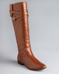These GUESS flat boots are basics with lots of style; criss cross buckled straps and flap details add distinctive touches to the design. These GUESS flat boots are basics with lots of style; criss cross buckled straps and flap details add distinctive touches to the design.