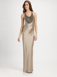 This sleek, silky design features a dramatic, jewel-encrusted bib and an alluring back cutout.ScoopneckSleevelessJeweled bibRacerbackBack cutout with drapeAbout 48 from natural waist75% triacetate/25% polyesterDry cleanMade in USA of imported fabricModel shown is 5'11 (180cm) wearing US size 4.OUR FIT MODEL RECOMMENDS ordering true size. This sleek, silky design features a dramatic, jewel-encrusted bib and an alluring back cutout.ScoopneckSleevelessJeweled bibRacerbackBack cutout with drapeAbout 48 from natural waist75% triacetate/25% polyesterDry cleanMade in USA of imported fabricModel shown is 5'11 (180cm) wearing US size 4.OUR FIT MODEL RECOMMENDS ordering true size.