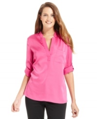 Calvin Klein's latest blouse features a contemporary notched V-neckline and chic fit that does the job at work or on the weekend. Calvin Klein's latest blouse features a contemporary notched V-neckline and chic fit that does the job at work or on the weekend.