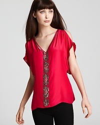 The lady in red gets a modern makeover with this Parker top. The cutout shoulder details and ornate beading are a sweet style twist. Pair it with your favorite skinny jeans and heels. The lady in red gets a modern makeover with this Parker top. The cutout shoulder details and ornate beading are a sweet style twist. Pair it with your favorite skinny jeans and heels.
