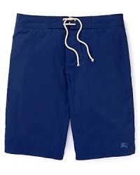 Solid easy-to-dry swim trunks with a tonal logo on the lower left leg shore up your sporty poolside style. From Burberry Brit. Solid easy-to-dry swim trunks with a tonal logo on the lower left leg shore up your sporty poolside style. From Burberry Brit.