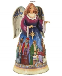 A colorific nativity scene paints itself across this folk-inspired angel's dress and adds to the hopeful & peaceful aura of this accent piece. A colorific nativity scene paints itself across this folk-inspired angel's dress and adds to the hopeful & peaceful aura of this accent piece.