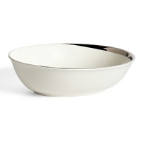 This oval vegetable bowl glows with a hand-painted bright platinum design to create a contemporary classic on your table that will complement your dining experience throughout a lifetime of shifting trends and evolving fashions. This oval vegetable bowl glows with a hand-painted bright platinum design to create a contemporary classic on your table that will complement your dining experience throughout a lifetime of shifting trends and evolving fashions.