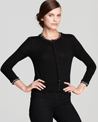 Preppy, pretty and professional, this DKNY sweater flaunts decadent embellishment at the collar and cuffs for a lustrous approach to layering. Preppy, pretty and professional, this DKNY sweater flaunts decadent embellishment at the collar and cuffs for a lustrous approach to layering.