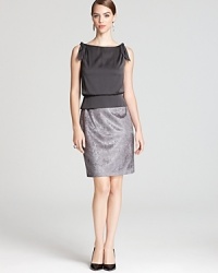 In soft grey hues, Aidan Mattox's two-tone dress pairs a silky bodice with a shimmering skirt reminiscent of crushed velvet. In soft grey hues, Aidan Mattox's two-tone dress pairs a silky bodice with a shimmering skirt reminiscent of crushed velvet.