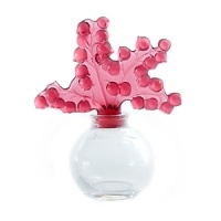 First introduced in 1931 by Rene Lalique, this striking perfume bottle features a sculptural lily-of-the-valley stopper in lush raspberry red. First introduced in 1931 by Rene Lalique, this striking perfume bottle features a sculptural lily-of-the-valley stopper in lush raspberry red.