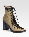 Smooth laces wrap around this edgy leather silhouette, with an open toe and towering stacked heel for a dramatic effect. Stacked heel, 4¼ (110mm)Suede upperOpen toeLeather lining and solePadded insoleMade in Italy