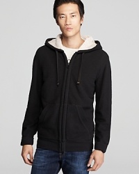 Lined in fleece for superior comfort, this designer hoodie equips you with a sporty layer that's easy to wear and generously warm. Lined in fleece for superior comfort, this designer hoodie equips you with a sporty layer that's easy to wear and generously warm.