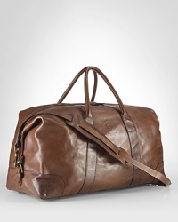 An ideal size for travel, this heritage duffle is rendered in durable cotton twill with glossy leather accents and a removable webbed shoulder strap for versatile on-the-go styling. An ideal size for travel, this heritage duffle is rendered in durable cotton twill with glossy leather accents and a removable webbed shoulder strap for versatile on-the-go styling.