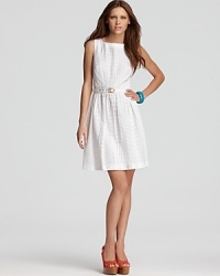 A white Trina Turk dress adopts the season's crispest trend, adding whimsical eyelet and a pleated skirt for ladylike chic. A white Trina Turk dress adopts the season's crispest trend, adding whimsical eyelet and a pleated skirt for ladylike chic.