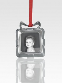 A charming way to hang a cherished photo on your tree, this sweet frame is designed to look like a tiny present with an abstract bow on top.Metal alloy and glassHandmadeSigned by designer Alvaro Uribe3.25H X 3WImported A charming way to hang a cherished photo on your tree, this sweet frame is designed to look like a tiny present with an abstract bow on top.Metal alloy and glassHandmadeSigned by designer Alvaro Uribe3.25H X 3WImported