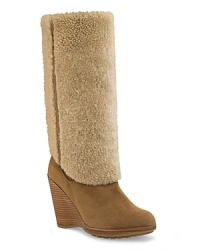 Take shearling-chic to new heights with these inside-out wedge boots from UGG® Collection. Take shearling-chic to new heights with these inside-out wedge boots from UGG® Collection.