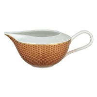 Embellished with an organically complex basket weave pattern and rendered in gold-tipped earthy hues, the Reynaud Tresor orange creamer lends boho-chic sophistication to the dining table.