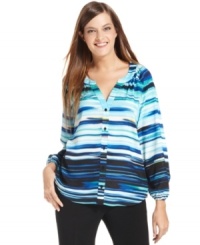 Calvin Klein's blouse features a blurred stripe print and relaxed fit for a feminine look. Calvin Klein's blouse features a blurred stripe print and relaxed fit for a feminine look.