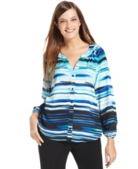 Calvin Klein's blouse features a blurred stripe print and relaxed fit for a feminine look.