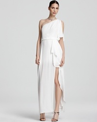BCBGMAXAZRIA masters modern glamour with this floor-sweeping gown, boasting a one-shoulder silhouette and cascading skirt. BCBGMAXAZRIA masters modern glamour with this floor-sweeping gown, boasting a one-shoulder silhouette and cascading skirt.