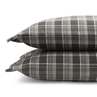 Inspired by the refined polish of menswear, this relaxed collection pairs solid brushed cotton and twill with faux suede trim and plaid. Sheets and pillowcases are in a soft cotton bold plaid in a grey and white palette. Inspired by the refined polish of menswear, this relaxed collection pairs solid brushed cotton and twill with faux suede trim and plaid. Sheets and pillowcases are in a soft cotton bold plaid in a grey and white palette.
