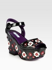 A flower appliqué adds dimension to this leather wedge silhouette with an adjustable ankle strap. Self-covered wedge, 3¾ (95mm)Covered platform, 1¾ (45mm)Compares to a 2 heel (50mm)Leather upperAdjustable ankle strapLeather lining and solePadded insoleMade in Italy A flower appliqué adds dimension to this leather wedge silhouette with an adjustable ankle strap. Self-covered wedge, 3¾ (95mm)Covered platform, 1¾ (45mm)Compares to a 2 heel (50mm)Leather upperAdjustable ankle strapLeather lining and solePadded insoleMade in Italy