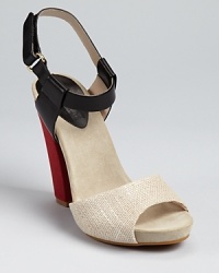 Shimmering burlap wraps around Juicy Couture's Flash sandals, a color blocked style finished with a trend-right block heel. Shimmering burlap wraps around Juicy Couture's Flash sandals, a color blocked style finished with a trend-right block heel.